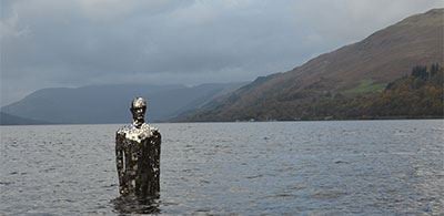 Metal sculpture The four season stands in the calm waters of Loch Earn 