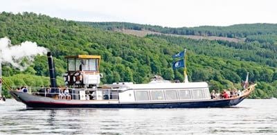 The Steam yacht Gondola on the water  with a forest background