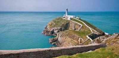 South Stack Lighthouse upon rocky peninsula overlooking sea