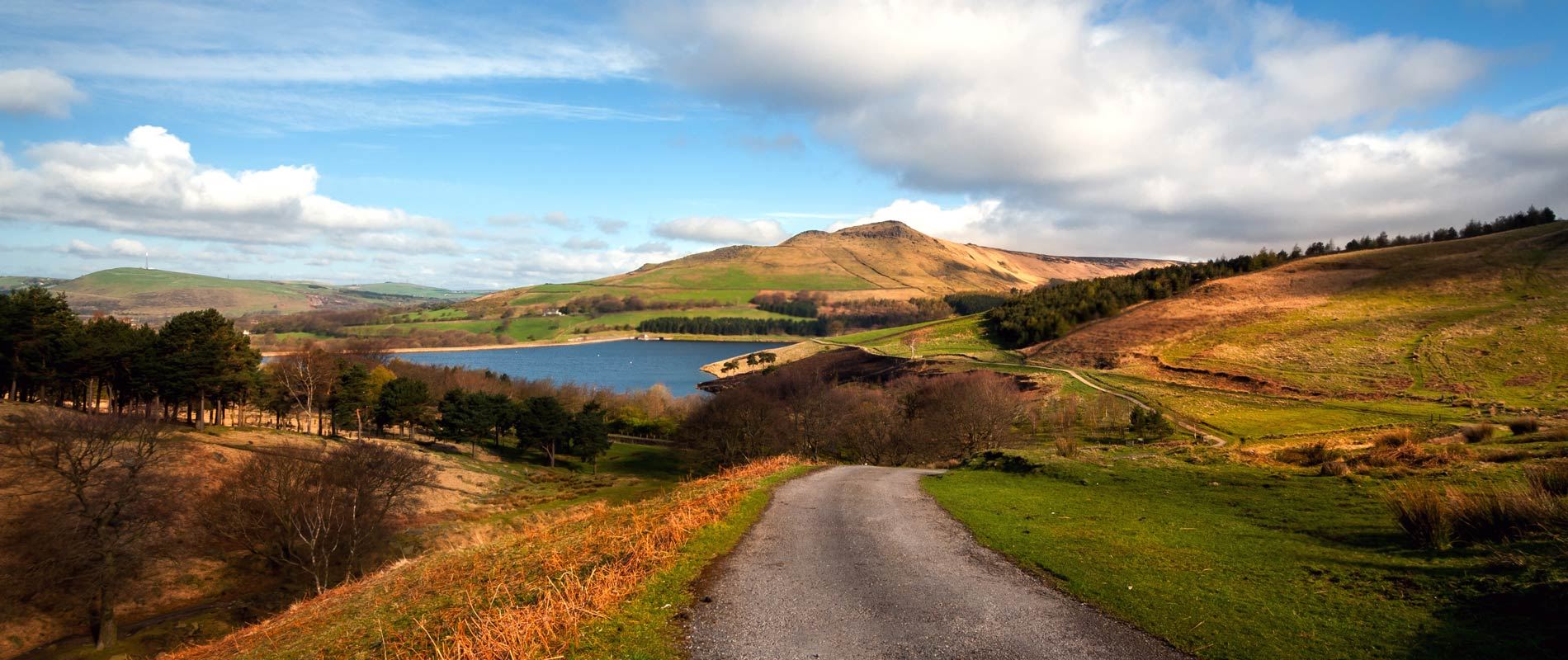 roling hills of the peak district with a calm  lake 