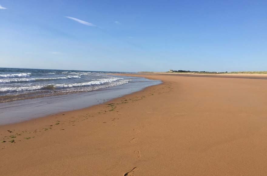 Golden sands and lapping waves at Brora Beach, Scotland