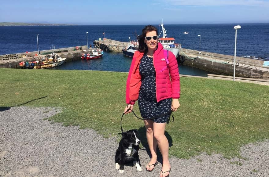 Woman enjoying seaside sunshine at John O'Groats