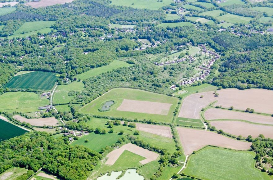 An ariel view of the Surrey countryside showing an impressive lusciously green landscape 