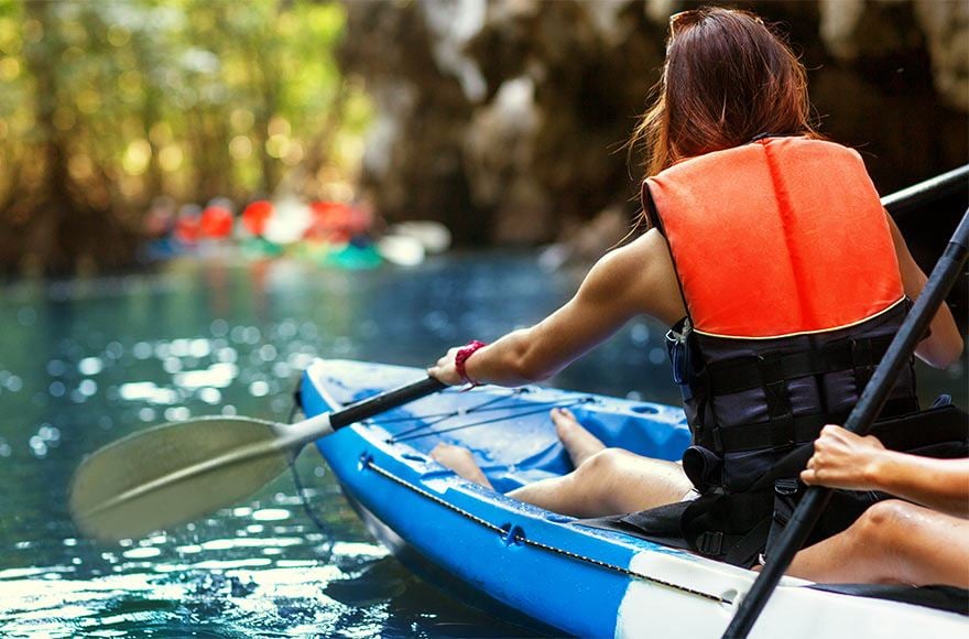 Group of people kayaking along a river