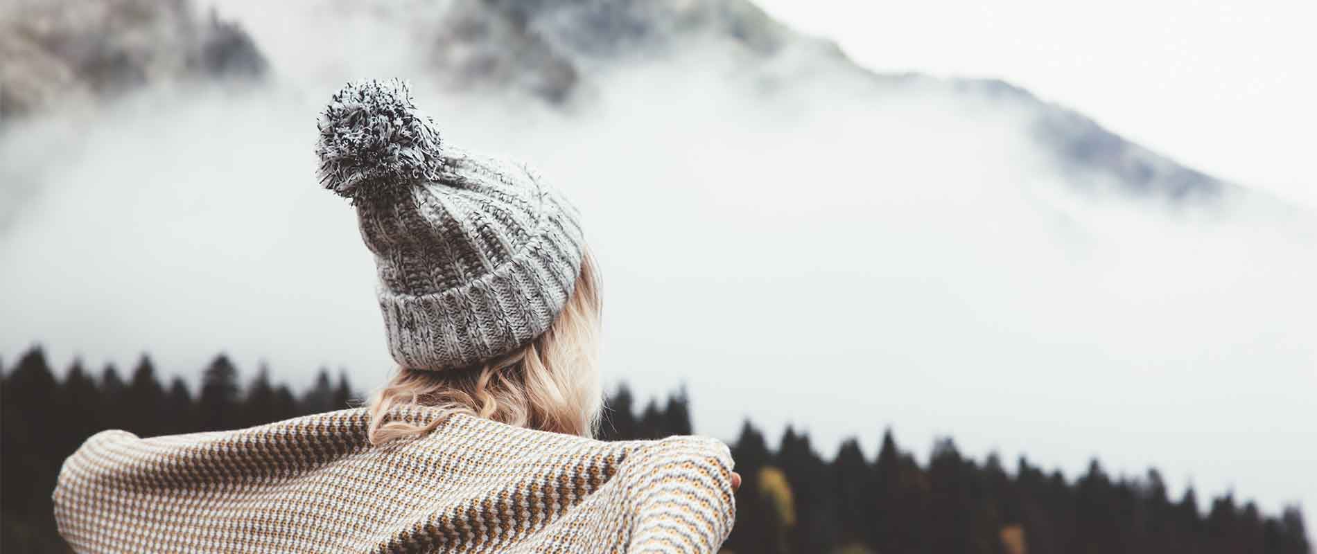 Girl staying warm in winter dry setting wearing a knitted bobble hat