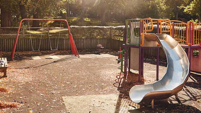 Swings and climbing frame at children's playground, Abbey Wood Club Campsite