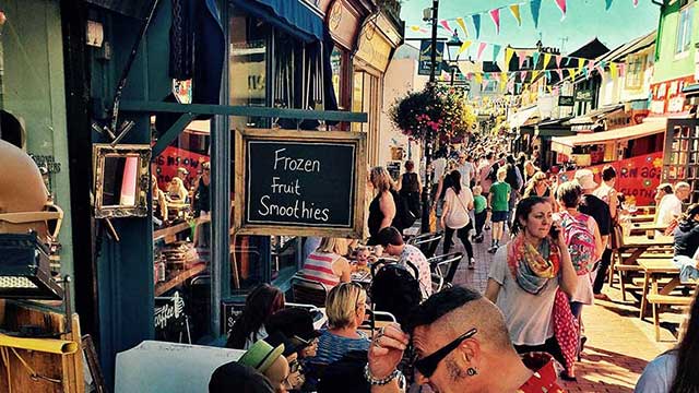 Shoppers strolling through Brighton's colourful North Laines