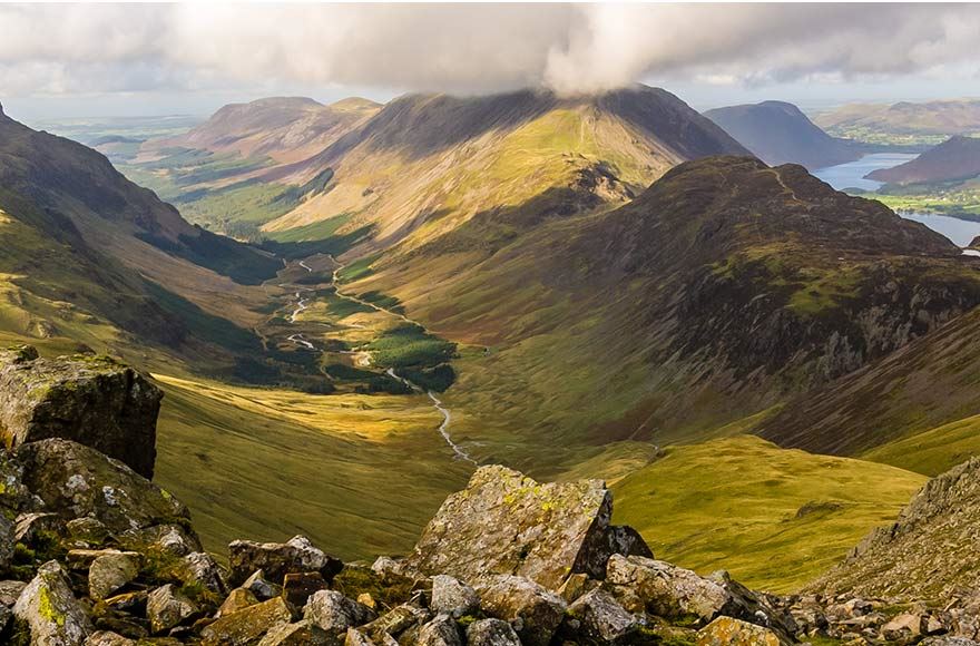 Panoramic views of the Cumbrian landscape with rocky terrain and cloudy sky  