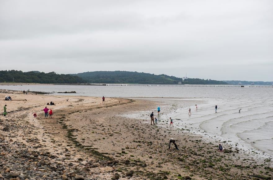 People on the beach against a dark sky 