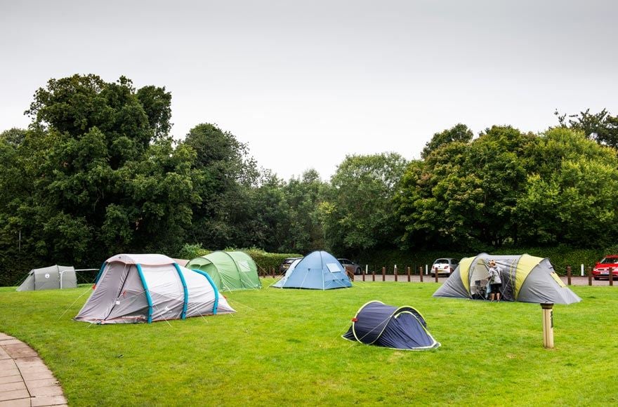 A group of Tents pitched in a field