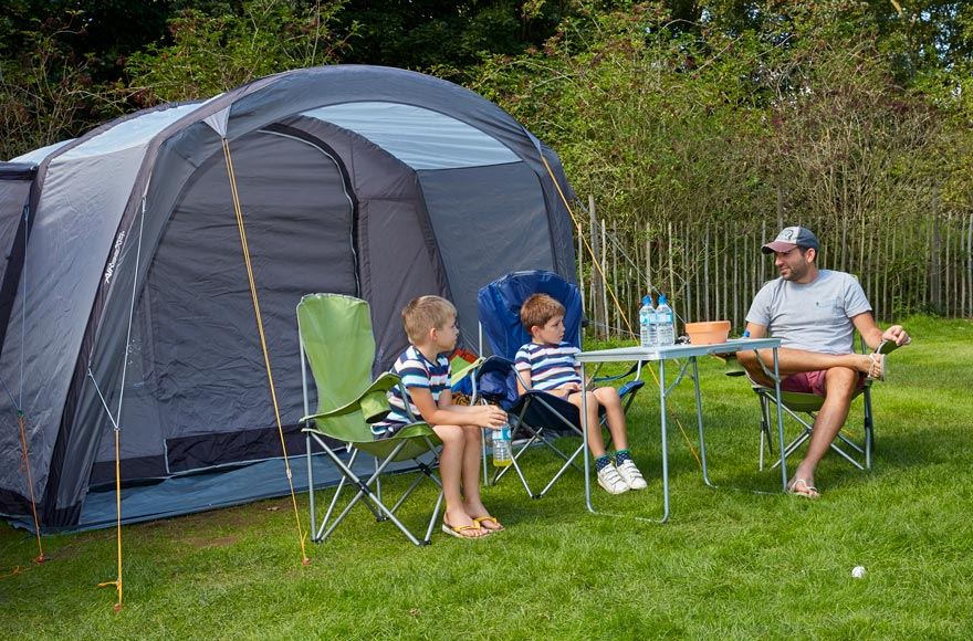 family at table outside tent at Ferry Meadows