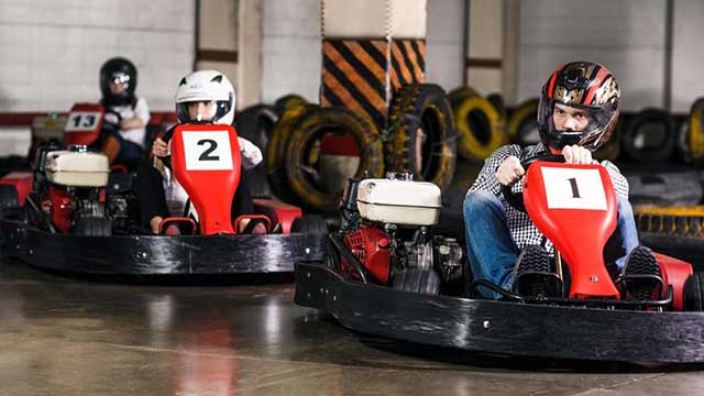 Drivers race brightly-coloured go-karts in Crawley, near Gatwick Club Campsite 