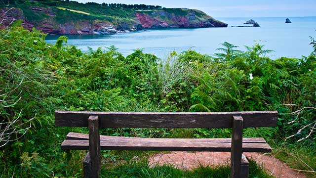 Views across the sea of St Mary's Bay Brixham from a bench at Hillhead Club Campsite