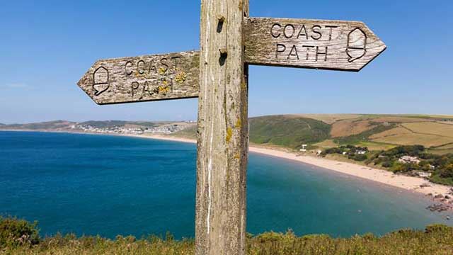 Wooden sign points the way on the coastal path