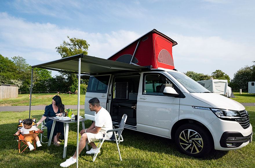 Family enjoying food outside their motorhome