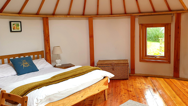 Cozy bedroom with bed and window, natural light