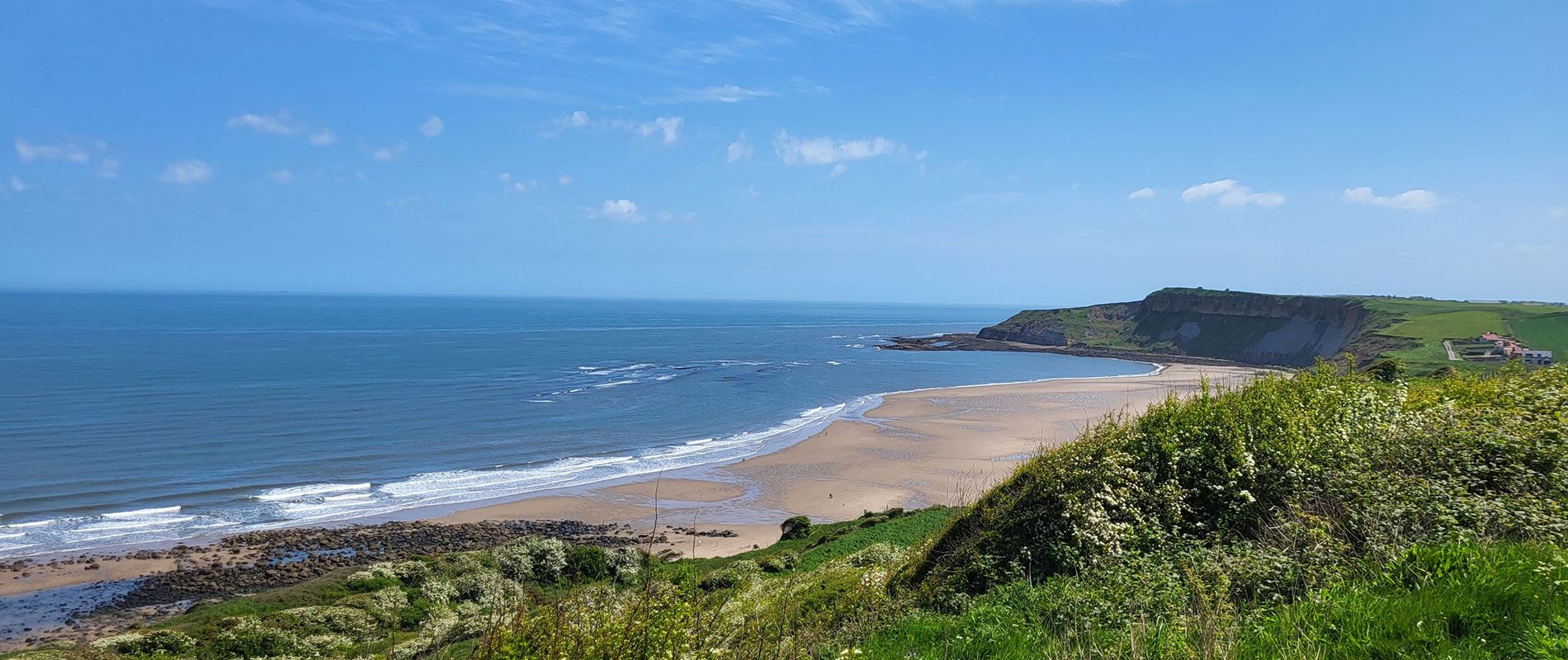 green hills and beach at cayton bay 