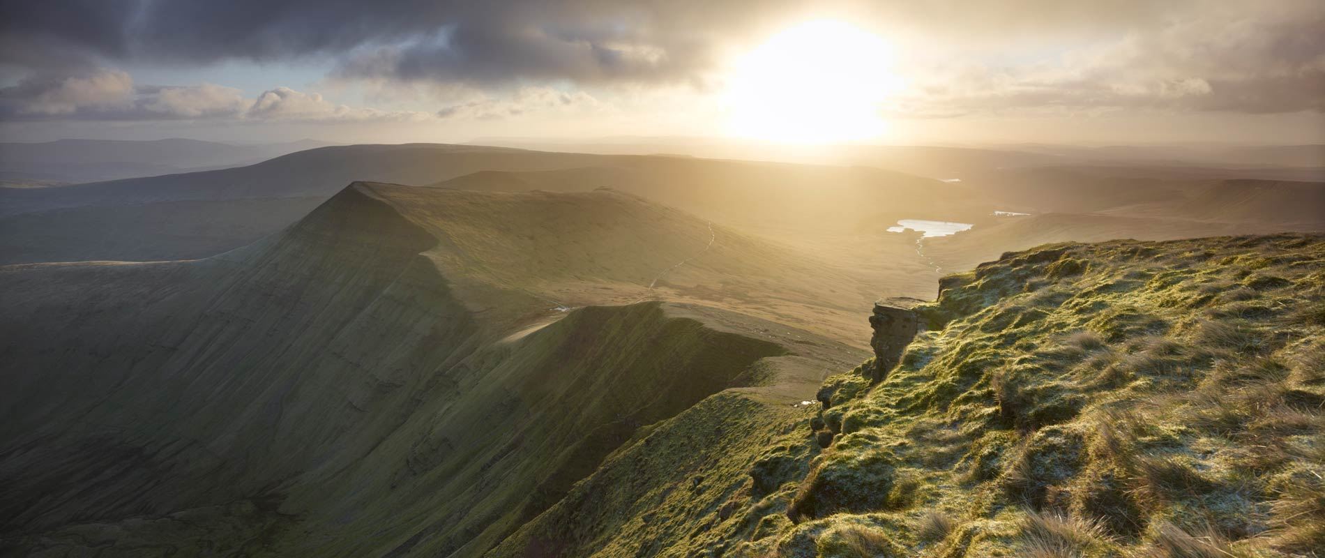 the rocky terrain hilltops of Powys bathed in soft sunlight 