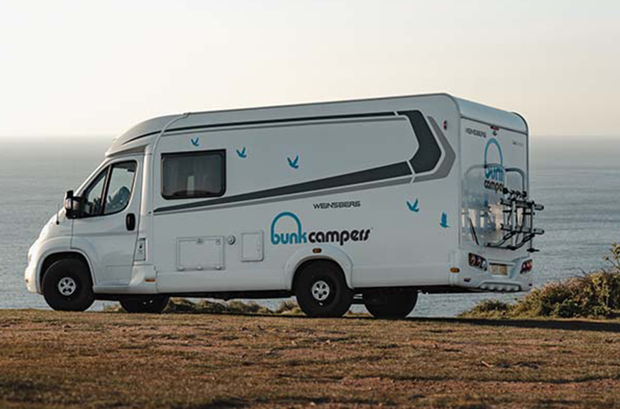 Bunk campervan with a sea view in the background 