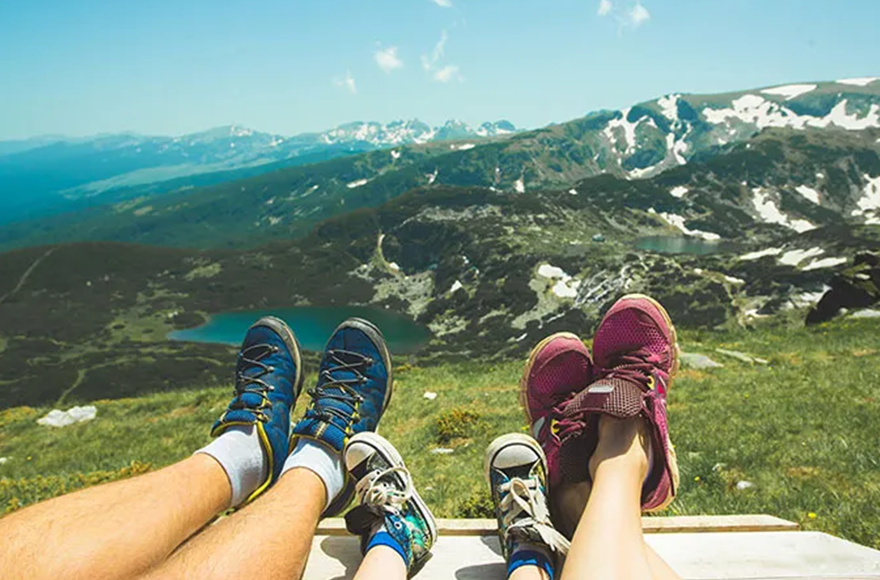 feet of a family with a mountain background