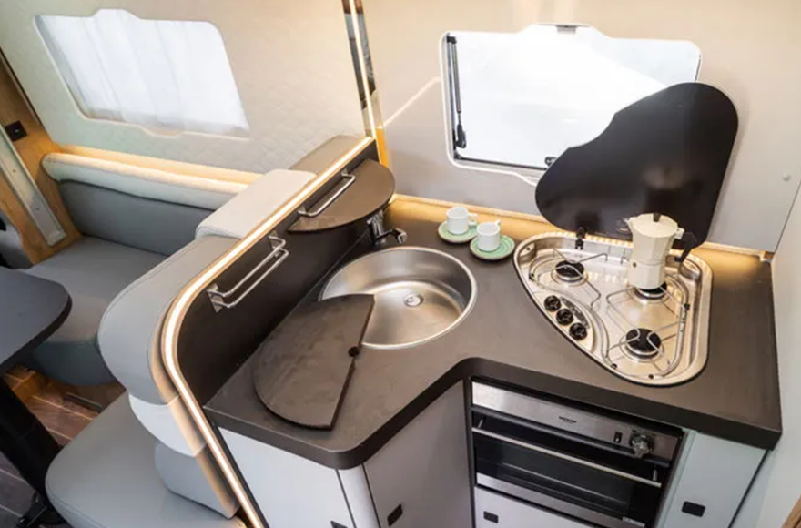 kitchen area of just go campervan  with sink and oven