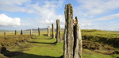 stone rings of brodgar sitting on a green landscape