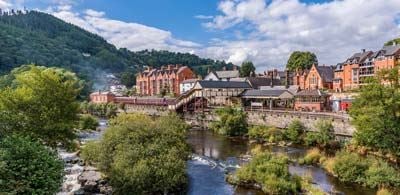 Trees and river with views of picturesque Llangollen town