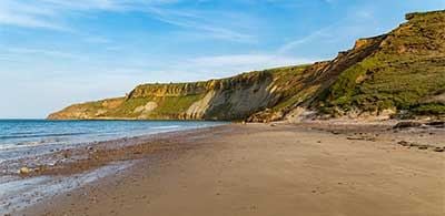 Golden sands and cliff side of Scarborough North Bay